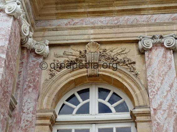 French pilaster capitals and a window.